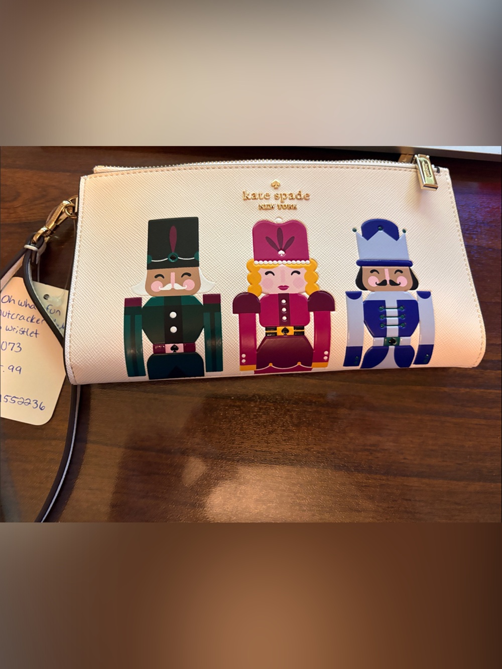 kate spade beige wristlet with colorful nutcracker trio